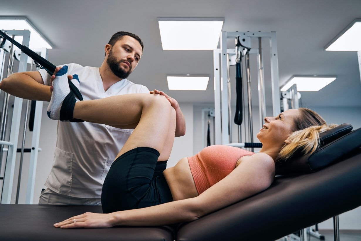 Physio exercising the leg area of the lady using bands