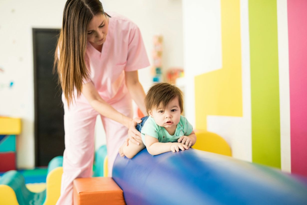 Baby crawling on a beam and practicing balance