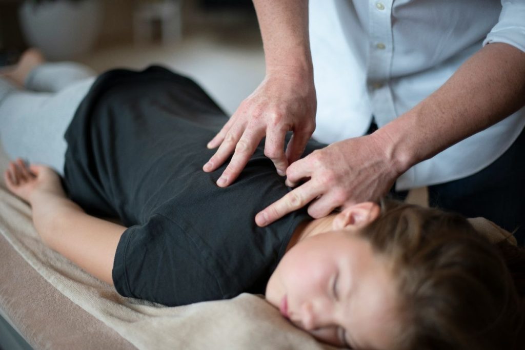 Physiotherapist treating a young girl