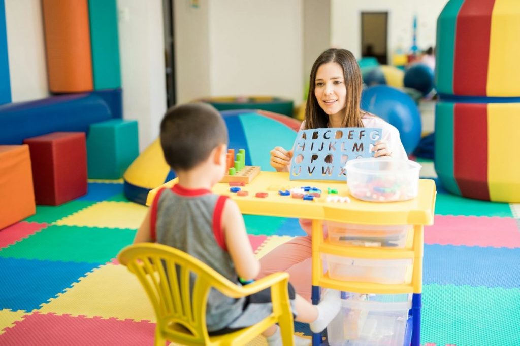 Female language therapist working with a boy